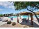 Relaxing pool area with shaded seating and lounge chairs at Anthem Golf & Country Club at 2452 W Muirfield Dr, Anthem, AZ 85086