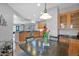 Dining area adjacent to kitchen featuring a wooden table, 4 chairs, and lots of lighting at 2452 W Muirfield Dr, Anthem, AZ 85086
