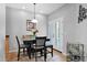 Dining area featuring a wood table, 4 chairs, french doors, and tile flooring at 2452 W Muirfield Dr, Anthem, AZ 85086