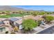Desert community home next to golf course with lush landscaping and a solar panel roof at 2452 W Muirfield Dr, Anthem, AZ 85086