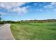 Beautifully landscaped golf course with lush green fairways and desert-style vegetation at 2452 W Muirfield Dr, Anthem, AZ 85086