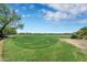 Picturesque golf course with a clear blue sky, lush green fairways and carts at 2452 W Muirfield Dr, Anthem, AZ 85086