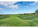 Expansive view of the lush green golf course and manicured landscaping at 2452 W Muirfield Dr, Anthem, AZ 85086