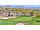 Scenic view of the golf course with mountain backdrop and golf carts on the path at 2452 W Muirfield Dr, Anthem, AZ 85086