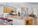 Bright kitchen with stainless appliances, wooden cabinets, granite countertops and bar seating at 2452 W Muirfield Dr, Anthem, AZ 85086