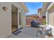 Back patio features seating, grill, and an access door to the home's interior at 2452 W Muirfield Dr, Anthem, AZ 85086