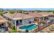 Inviting backyard pool with desert landscaping and mountain views provides a relaxing retreat at 2452 W Muirfield Dr, Anthem, AZ 85086