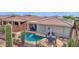 Beautiful backyard pool area with ample seating and desert landscaping offers a relaxing retreat at 2452 W Muirfield Dr, Anthem, AZ 85086