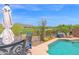 Backyard pool area overlooking desert golf course with lounge chairs and ample seating for outdoor enjoyment at 2452 W Muirfield Dr, Anthem, AZ 85086