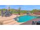 Stunning backyard pool with waterfall feature, seating and beautiful desert golf course views at 2452 W Muirfield Dr, Anthem, AZ 85086
