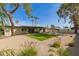 Spacious backyard featuring artificial lawn, a patio, a firepit and palm trees at 2517 E Sahuaro Dr, Phoenix, AZ 85028
