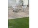 Backyard with a charming stone firepit and white patio chairs at 2517 E Sahuaro Dr, Phoenix, AZ 85028