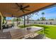Cozy backyard patio with dining and lounge area with artificial lawn and palm tree views at 2517 E Sahuaro Dr, Phoenix, AZ 85028