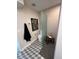 Modern bathroom with patterned tile, floating vanity, toilet, and walk-in shower with glass partition at 2517 E Sahuaro Dr, Phoenix, AZ 85028