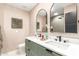 Bathroom featuring a double sink vanity, modern fixtures, and decorative mirrors for a spa-like experience at 2517 E Sahuaro Dr, Phoenix, AZ 85028