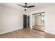 Bright bedroom features wood floors, a ceiling fan and mirrored closet doors at 2517 E Sahuaro Dr, Phoenix, AZ 85028