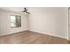 Clean bedroom showcasing wood floors, white walls, a ceiling fan and a bright window at 2517 E Sahuaro Dr, Phoenix, AZ 85028