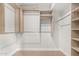 Bright walk-in closet with built-in shelving and hanging rods at 2517 E Sahuaro Dr, Phoenix, AZ 85028