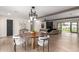 Chic dining area showcasing modern lighting, stylish chairs, and seamless flow into the living space at 2517 E Sahuaro Dr, Phoenix, AZ 85028