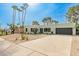 Modern home with desert landscaping, tall palm trees, and a sleek, minimalist design at 2517 E Sahuaro Dr, Phoenix, AZ 85028