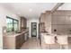 Modern kitchen with stainless steel appliances, granite counters and breakfast bar seating for two at 2517 E Sahuaro Dr, Phoenix, AZ 85028