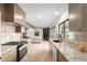 Modern kitchen with granite counters, stainless steel appliances and light colored floors throughout the home at 2517 E Sahuaro Dr, Phoenix, AZ 85028