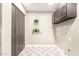 Functional laundry room with built-in cabinets and tiled floors at 2517 E Sahuaro Dr, Phoenix, AZ 85028