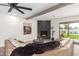 Cozy living room featuring a modern fireplace, plush sofa, and views of the backyard at 2517 E Sahuaro Dr, Phoenix, AZ 85028