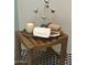 Close-up of a stylish shower with a wooden stool, towels, candle, and elegant tile at 2517 E Sahuaro Dr, Phoenix, AZ 85028