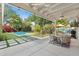 Backyard showcasing a covered patio, pool, grill, dining area, and lush landscaping at 252 E Orange Dr, Phoenix, AZ 85012