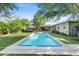 Inviting backyard pool with a modern patio, framed by lush landscaping and a well-maintained lawn at 252 E Orange Dr, Phoenix, AZ 85012