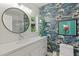 Charming bathroom featuring a single sink vanity and patterned accent wall at 252 E Orange Dr, Phoenix, AZ 85012