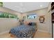 Light bedroom with modern furnishings, two windows, artwork, and an overhead fan at 252 E Orange Dr, Phoenix, AZ 85012