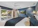 Bedroom with access to the outdoor patio seating area, desk, and built-in bookshelves at 252 E Orange Dr, Phoenix, AZ 85012