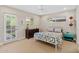Bright bedroom with a white ceiling fan, a full sized bed, and outdoor access at 252 E Orange Dr, Phoenix, AZ 85012