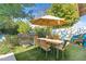 Outdoor dining area with a grill, seating for six, and a unique mural at 252 E Orange Dr, Phoenix, AZ 85012