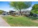 Well-kept home with a spacious front lawn, mature trees, and a 'Coming Soon' sign, offering curb appeal at 252 E Orange Dr, Phoenix, AZ 85012