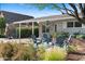 Inviting front exterior with blue Adirondack chairs, lush landscaping, and a charming façade at 252 E Orange Dr, Phoenix, AZ 85012