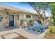 Cozy front porch featuring stylish outdoor seating, a patterned rug, and attractive landscaping at 252 E Orange Dr, Phoenix, AZ 85012