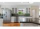 Bright kitchen featuring stainless steel appliances, dark countertops, and ample cabinet space at 252 E Orange Dr, Phoenix, AZ 85012