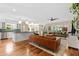 Spacious living room and kitchen with hardwood floors, modern lighting, and a view to a dining area at 252 E Orange Dr, Phoenix, AZ 85012