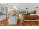 Open-concept living room and kitchen with hardwood floors and a view of the outdoor pool and garden at 252 E Orange Dr, Phoenix, AZ 85012