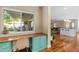 Desk area featuring wood floors, teal colored cabinets and open concept living at 252 E Orange Dr, Phoenix, AZ 85012
