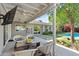 Cozy covered patio with stylish seating, ceiling fans, and serene backyard views, ideal for outdoor relaxation at 252 E Orange Dr, Phoenix, AZ 85012