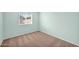 Bright bedroom featuring neutral carpet, one window with blinds, and light green colored walls at 2534 N 73Rd Dr, Phoenix, AZ 85035