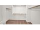 Walk-in closet with simple shelving and carpeted floors provides organized storage solutions at 2534 N 73Rd Dr, Phoenix, AZ 85035