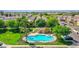 An aerial view of the community pool, cabana, lush landscaping, and plenty of parking at 2534 N 73Rd Dr, Phoenix, AZ 85035