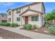 Charming townhome featuring a covered entry, well-kept landscaping, and a concrete walkway at 2534 N 73Rd Dr, Phoenix, AZ 85035
