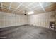 Spacious garage with concrete floor, utility door, and white walls at 2534 N 73Rd Dr, Phoenix, AZ 85035