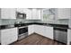 Updated kitchen featuring stainless steel appliances, black countertops, and white cabinets at 2534 N 73Rd Dr, Phoenix, AZ 85035
